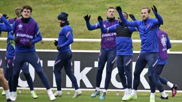 England's Harry Kane, right, warms-up with teammates during a training session at St George's Park, Burton upon Trent, England, Tuesday July 6