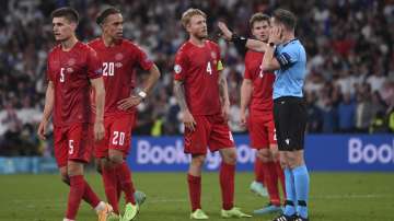 Referee Danny Makkelie checks with VAR for penalty during the Euro 2020 soccer semifinal match between England and Denmark at Wembley stadium in London, Wednesday, July 7