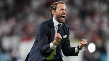 England's manager Gareth Southgate celebrates after winning the Euro 2020 soccer championship semifinal match against Denmark at Wembley stadium in London, Wednesday, July 7