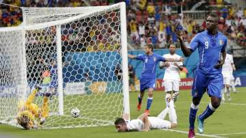 Italy's Mario Balotelli celebrates after scoring past England's goalkeeper Joe Hart