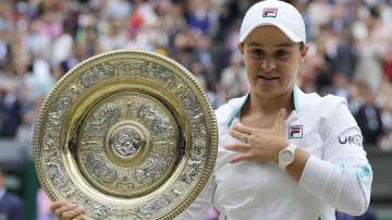 Australia's Ashleigh Barty poses with the trophy for the media after winning the women's singles final, defeating the Czech Republic's Karolina Pliskova on day twelve of the Wimbledon Tennis Championships in London, Saturday, July 10