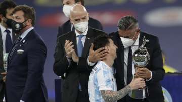 Argentine Football Association, (AFA) President Claudio Tapia, right, gives the trophy for the best player to Argentina's Lionel Messi during the award ceremony after defeating Brazil 1-0 in Copa America final soccer match at Maracana stadium in Rio de Janeiro, Brazil, Saturday, July 10,