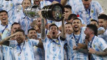Argentina's Lionel Messi hoists the trophy after beating Brazil 1-0 in the Copa America final soccer match at Maracana stadium in Rio de Janeiro, Brazil, Saturday, July 10