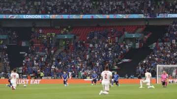The players take a knee before the Euro 2020 soccer championship final match between England and Italy at Wembley stadium in London, Sunday, July 11
