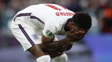 England's Marcus Rashford reacts after failing to score a penalty during a shootout at the end of the Euro 2020 soccer championship final match between England and Italy at Wembley stadium in London, Sunday, July 11