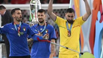 Italy's goalkeeper Gianluigi Donnarumma and his teammate Italy's Leonardo Spinazzola, left, celebrate after winning the Euro 2020 soccer championship final match between England and Italy at Wembley Stadium in London, Sunday, July 11