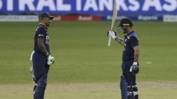 India's Ishan Kishan, right, celebrates scoring a half century with Shikhar Dhawan during the first one day international cricket match between Sri Lanka and India in Colombo, Sri Lanka, Sunday, July 18