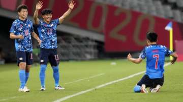 Japan's Ritsu Doan, left, and teammate Reo Hatate, second from left, celebrates a goal from Takefusa