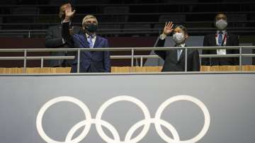 President of the IOC Thomas Bach, left, and Japan's Emperor Naruhito wave during the opening ceremony in the Olympic Stadium at the 2020 Summer Olympics, Friday, July 23