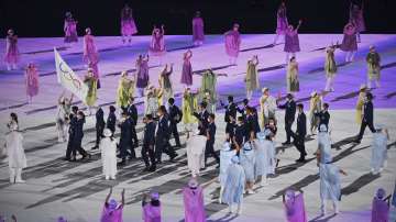 The refugee team carry the Olympic flag during the opening ceremony in the Olympic Stadium at the 2020 Summer Olympics, Friday, July 23