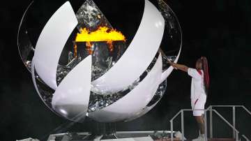 Naomi Osaka lights the Olympic flame during the opening ceremony in the Olympic Stadium at the 2020 Summer Olympics, Friday, July 23