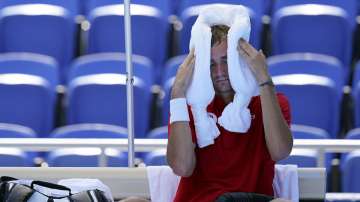 Daniil Medvedev, of the Russian Olympic Committee, cools off during a changeover in a tennis match against Alexander Bublik, of Kazakhstan, during at the 2020 Summer Olympics, Saturday, July 24