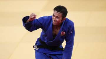 Naohisa Takato, of Japan, celebrates after defeating Yang Yung-wei, of Taiwan, in a men's 60-kg judo gold medal match at the 2020 Summer Olympics, Saturday, July 24