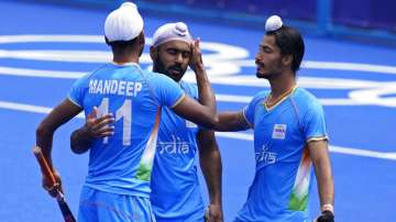 India's Mandeep Singh celebrates after India's Simranjeet Singh scores against Spain. 