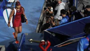 Naomi Osaka, of Japan, leaves center court after being defeated by Marketa Vondrousova, of the Czech Republic, during the third round of the tennis competition at the 2020 Summer Olympics, Tuesday, July 27