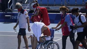 Paula Badosa, of Spain, is helped off the court in a wheelchair after retiring due to illness during the quarterfinals of the tennis competition at the 2020 Summer Olympics, Wednesday, July 28, 2021, in Tokyo