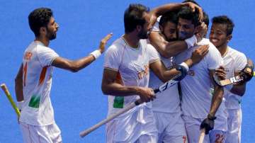 India's Varun Kumar (22) celebrates with his teammates after scoring 