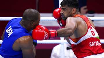 Satish Kumar, right, of India exchanges punches with Ricardo Brown of Jamaica 