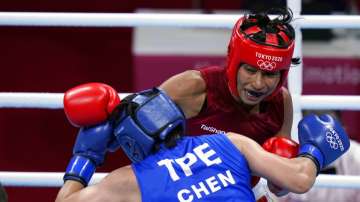 Lovlina Borgohain, of India, in red, delivers a punch to Nien-Chin Chen