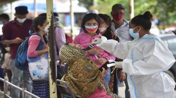 FILE| A health worker collects samples of passengers for Covid-19 test at city railway station during Covid-induced lockdown in Bengaluru, Saturday, July 24, 2021.