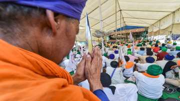 Farmers along with their families and supporters take part in a protest.