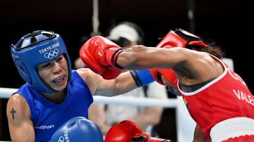Ingrit Lorena Valencia Victoria (red) of Team Colombia exchanges punches with Chungneijang Mery Kom Hmangte of Team India during the Women's Fly (48-51kg) on day six of the Tokyo 2020 Olympic Games at Kokugikan Arena on July 29