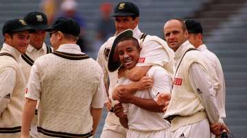 South Africa's Paul Adams receives a hug from his teammates 