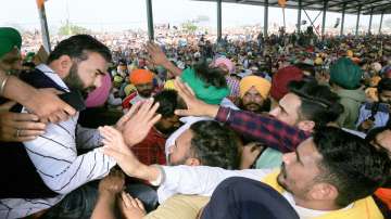 Lakha Sidhana (L), meets his supporters as he arrives to join farmers protest against the new farm laws, in Bathinda. 