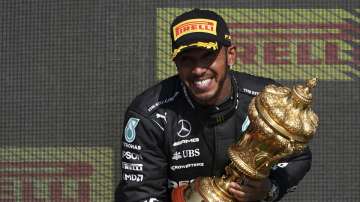 Mercedes driver Lewis Hamilton of Britain celebrates on the podium after winning the British Formula One Grand Prix, at the Silverstone circuit, in Silverstone, England, Sunday, July 18