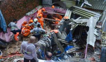 Firemen and rescue workers after a landslide in Vikroli area.