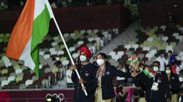 Chungneijang Mery Kom Hmangte and Manpreet Singh, of India, carry their country's flag during the opening ceremony in the Olympic Stadium at the 2020 Summer Olympics, Friday, July 23, 2021, in Tokyo
