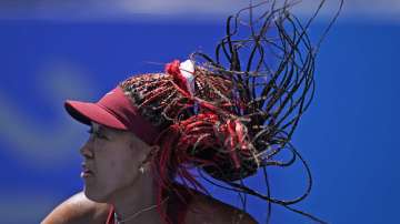 Naomi Osaka, of Japan, plays against Saisai Zheng, of China, during the first round of the tennis competition at the 2020 Summer Olympics, Sunday, July 25