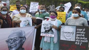 FILE | People during a silent protest over Father Stan Swamys death, outside Buddha Smriti park in Patna