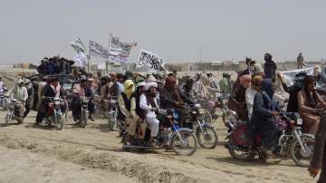  
In this July 14, 2021 file photo, supporters of the Taliban carry their signature white flags after the Taliban said they seized the Afghan border town of Spin Boldaka across from the town of Chaman, Pakistan. 