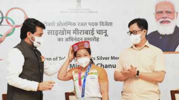 Union Ministers Anurag Thakur and Kiren Rijiju with Silver medalist in Tokyo Olympics, Weightlifter Saikhom Mirabai Chanu during her felicitation ceremony in New Delhi