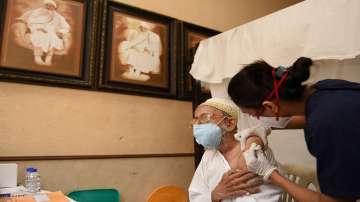 An elderly person receives a dose of Covid-19 vaccine, at a vaccination centre in Mohammedi Masjid complex, in Mumbai