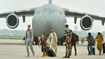 People who were stranded in crisis-hit Afghanistan arrive by a special repatriation flight of IAF at the Hindan Air Force Station, in Ghaziabad.