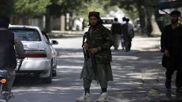 A Taliban fighter stands guard at a checkpoint in the Wazir Akbar Khan neighborhood in the city of Kabul, Afghanistan.