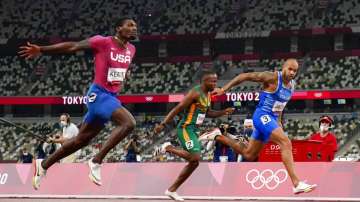 Lamont Jacobs, right, of Italy, wins the men's the 100-meter final at the 2020 Olympics