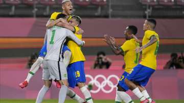 Brazil's players celebrate after defeating Mexico in a penalty shootout in a men's soccer semifinal match at the 2020 Summer Olympics, Tuesday, Aug. 3, 2021, in Kashima, Japan