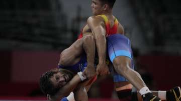 Bajrang Punia (in blue) in action against Ernazar Akmataliev pre-quarterfinals of 65kg freestyle wrestling in Tokyo on Sunday.