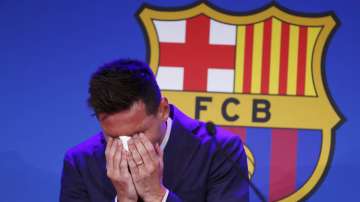 Lionel Messi cries at the start of a press conference at the Camp Nou stadium in Barcelona, Spain, Sunday, Aug. 8