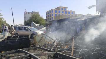 Smoke rises from damaged shops after fighting between Taliban and Afghan security forces in Kunduz city.