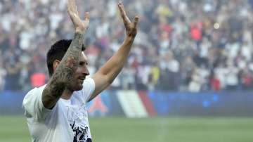 PSG's Lionel Messi waves during players presentation before the French League One soccer match between Paris Saint Germain and Strasbourg, at the Parc des Princes stadium in Paris, Saturday, Aug. 14