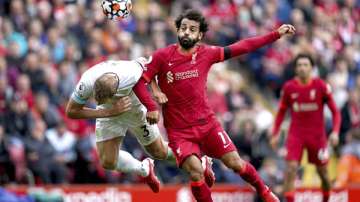 Liverpool's Mohamed Salah, right, and Burnley's Charlie Taylor battle for the ball during the English Premier League soccer match between Liverpool and Burnley at Anfield, Liverpool, England, Saturday Aug. 21