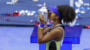 Naomi Osaka, of Japan, holds up the championship trophy after defeating Victoria Azarenka, of Belarus, in the women's singles final of the U.S. Open tennis championships in New York, in this Saturday, Sept. 12