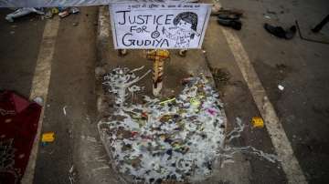 Melted candles are seen next to a placard at a demonstration site outside a crematorium where a 9-year-old girl from the lowest rung of India's caste system was, according to her parents and protesters, raped and killed earlier this week, in New Delhi.