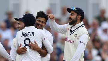 Shardul Thakur of India celebrates with Virat Kohli and Ravindra Jadeja after he took the wicket of Joe Root of England by lbw during day one of the First LV= Insurance test match between England and India at Trent Bridge on August 04