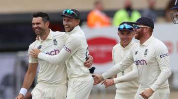 James Anderson of England celebrates taking the wicket of Virat Kohli of India with captain Joe Root during day two of the First LV= Insurance test match between England and India at Trent Bridge on August 05