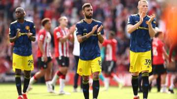 Aaron Wan-Bissaka, Bruno Fernandes and Scott McTominay of Manchester United